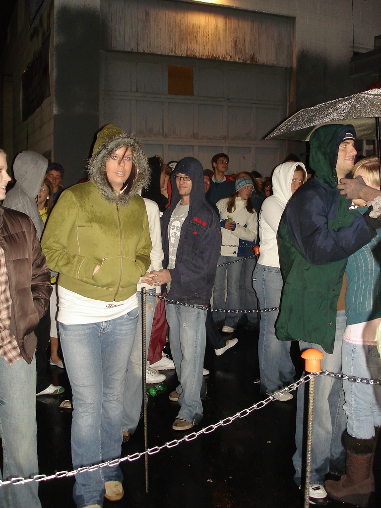 waiting in line for house of horror, people are crazy raining while waiting in line to enter house of horror